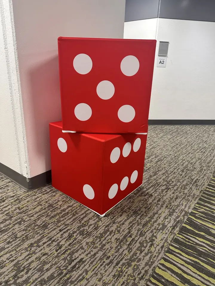 Oversized red dice used as casino-night event décor