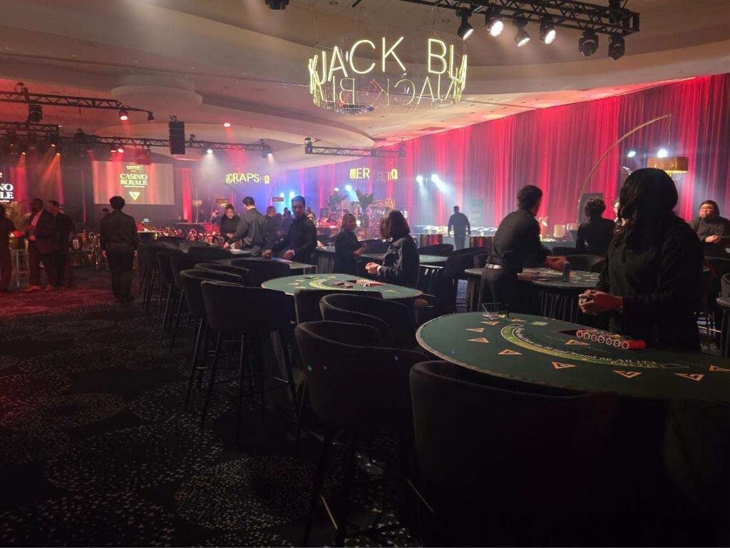Full casino event floor featuring coordinated custom-branded tables