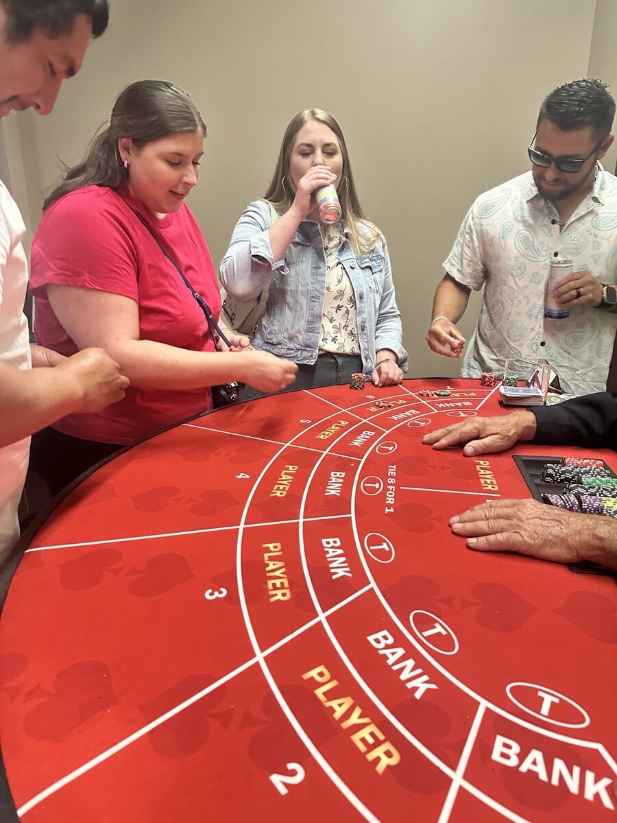 Guests playing Mini Baccarat at a 21 Fun casino-themed event