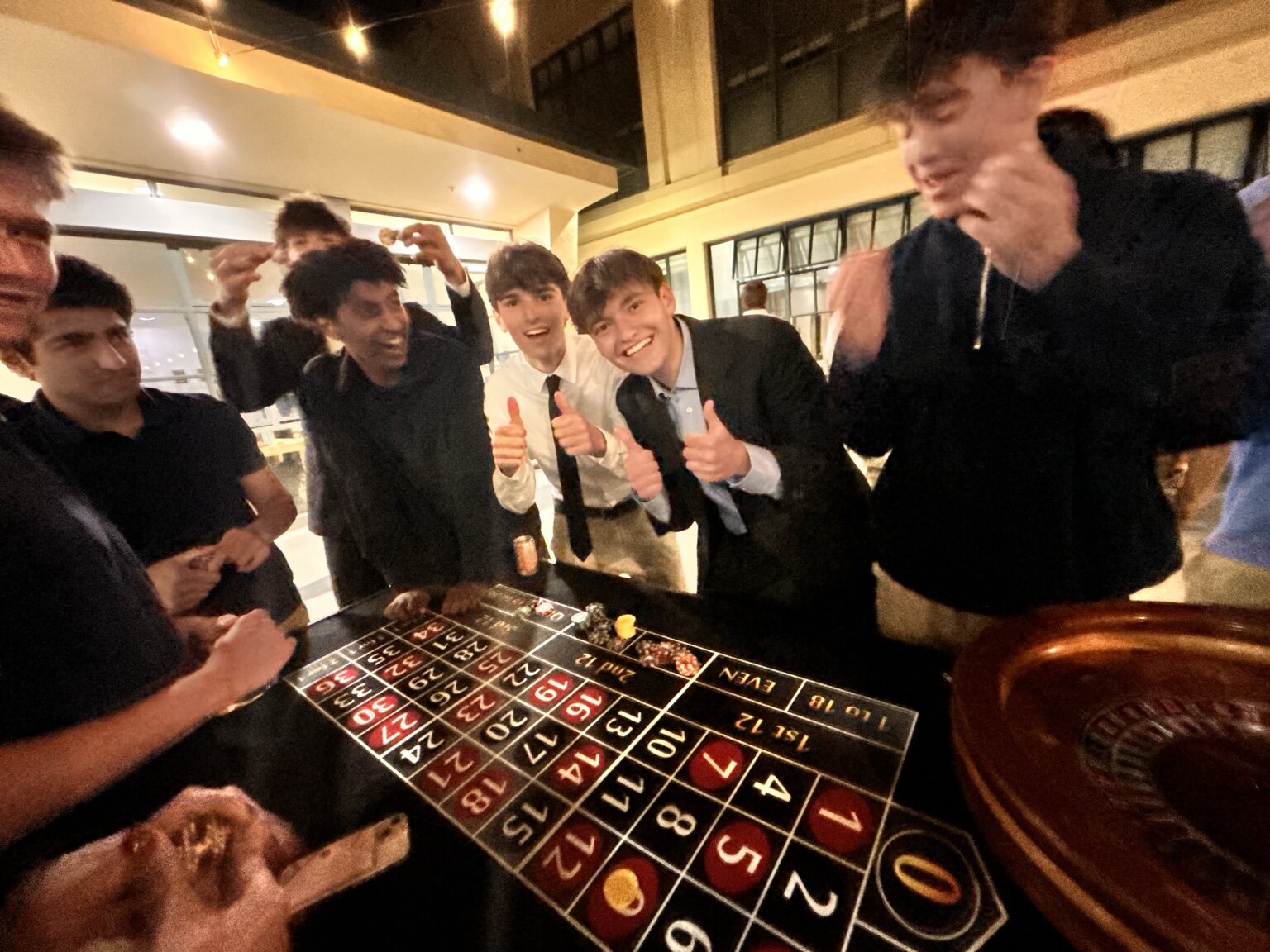 Students enjoying roulette together at a casino-themed event
