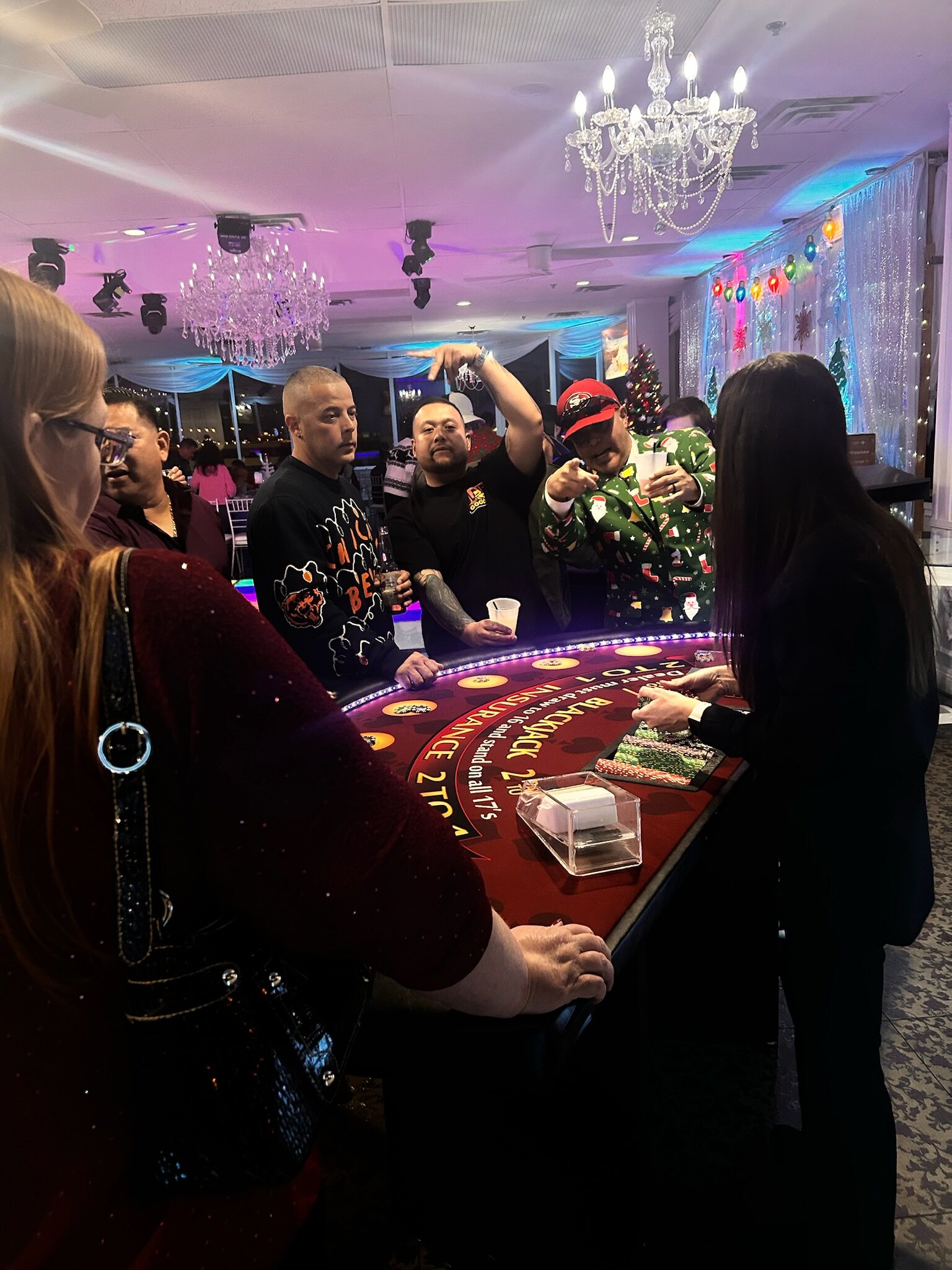 Guests connecting around a professionally staffed blackjack table