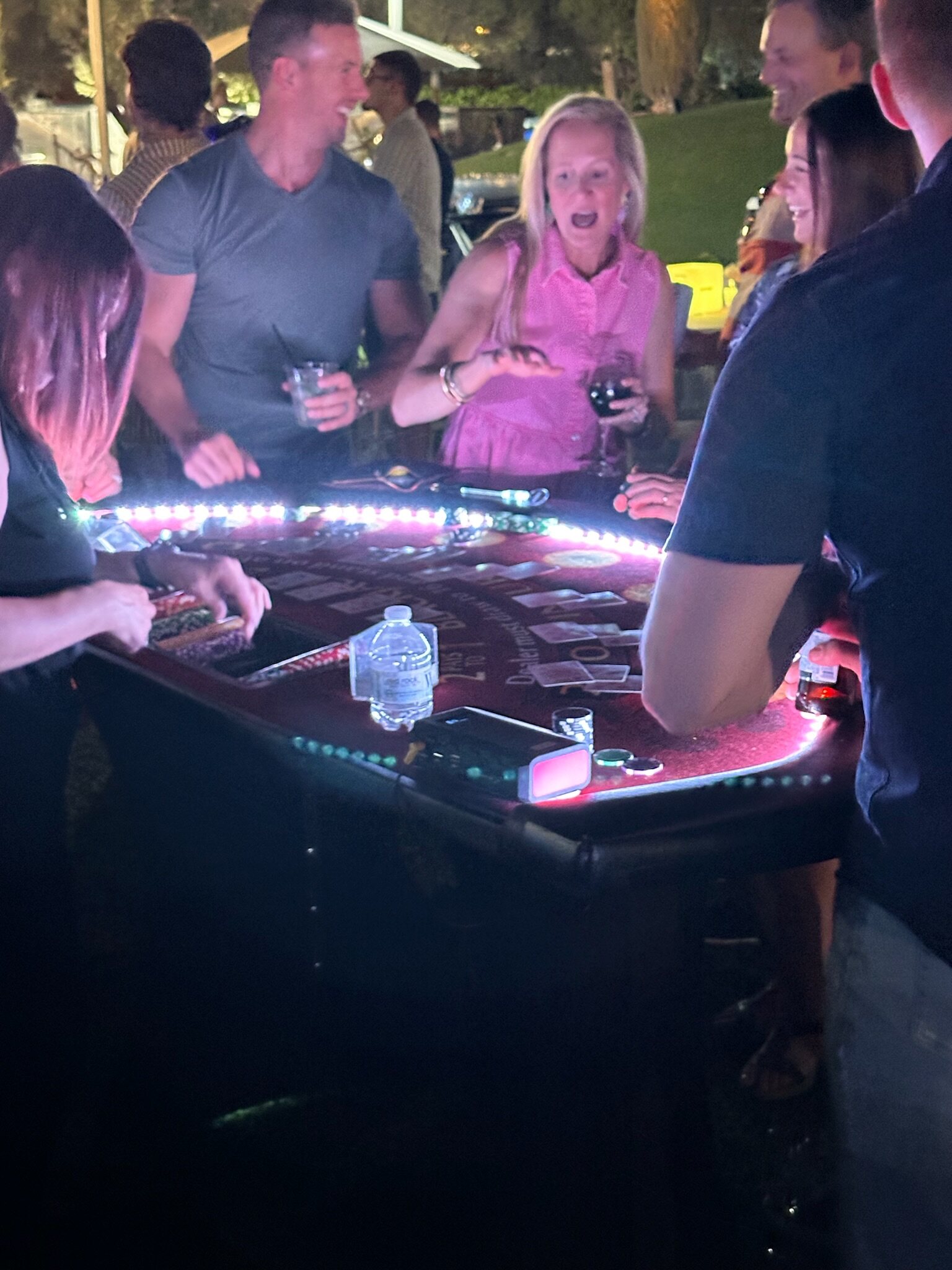 Friends sharing a lively casino-table experience