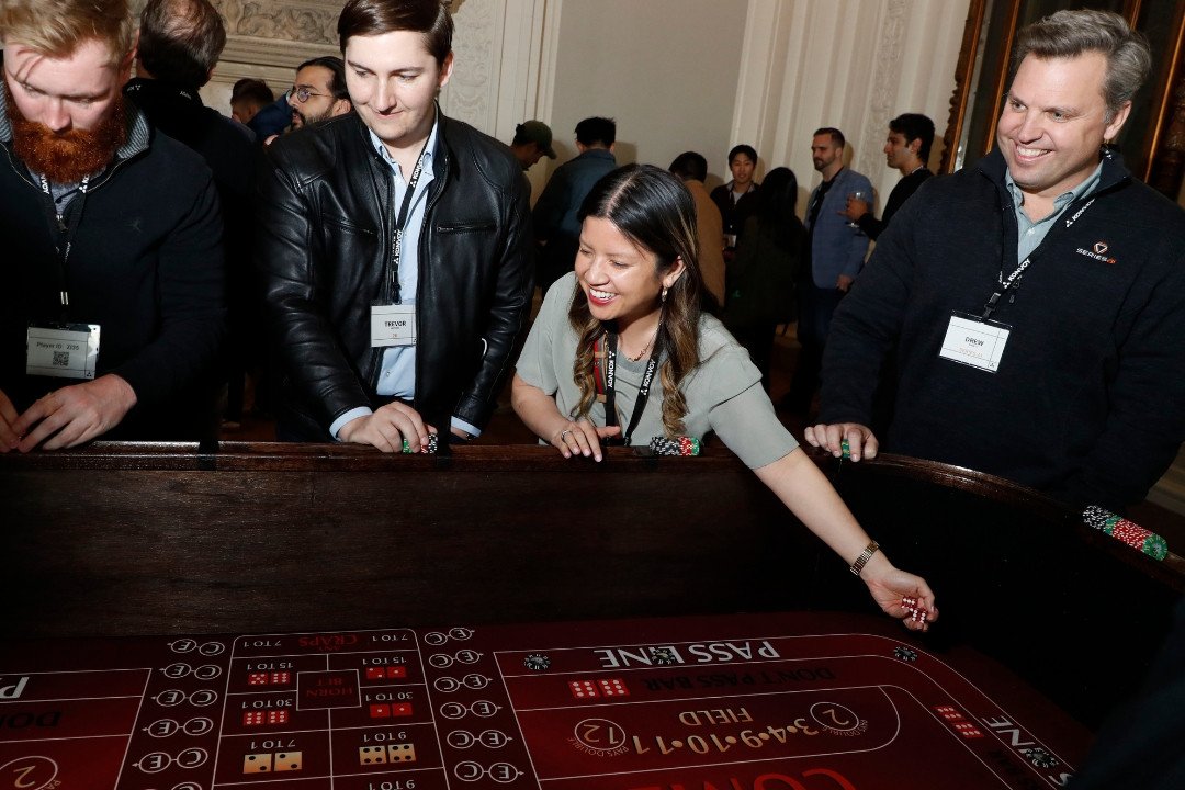 Guests enjoying craps at a 21 Fun casino-themed event