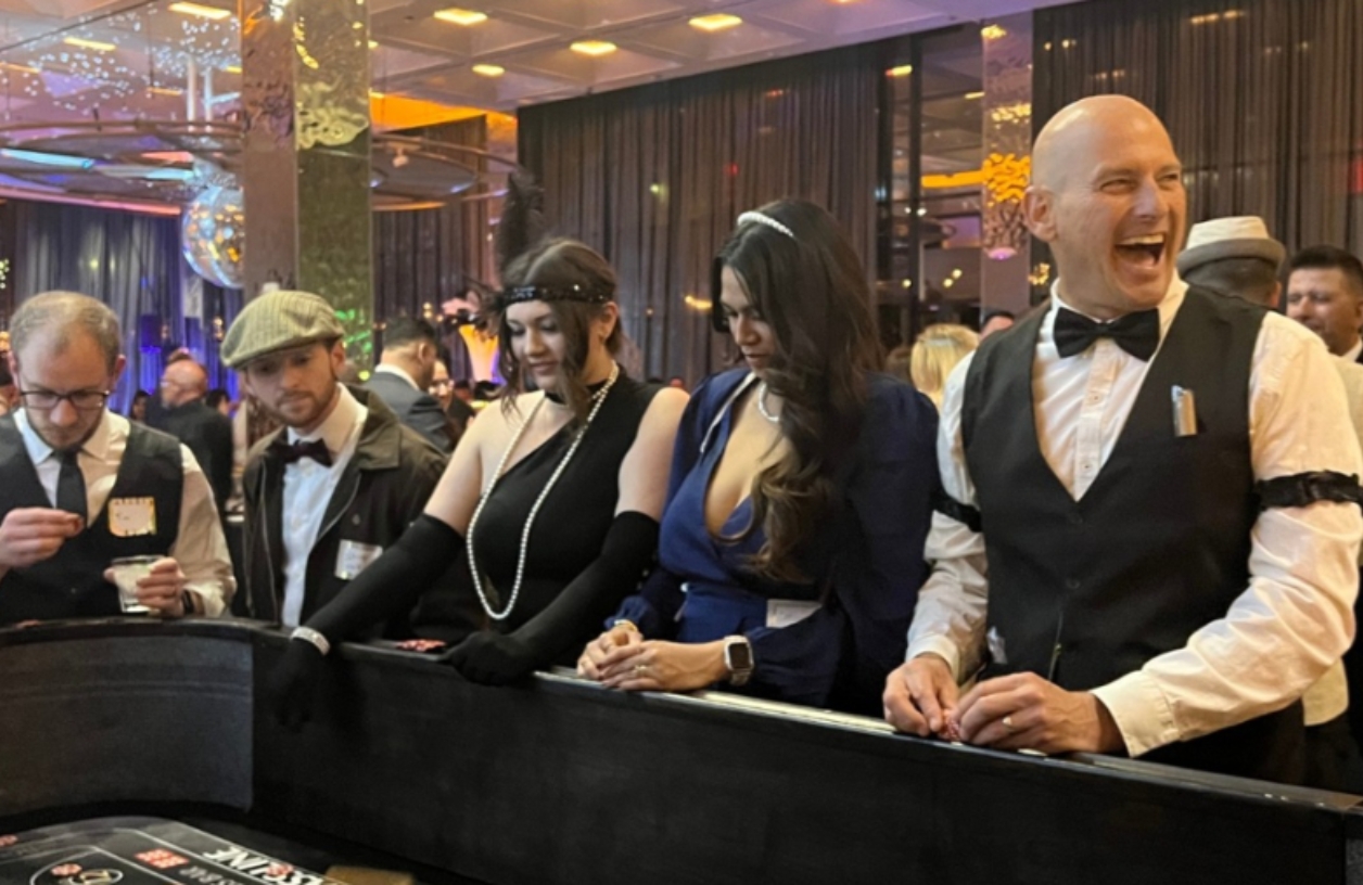 guests gathered around a casino table at an event