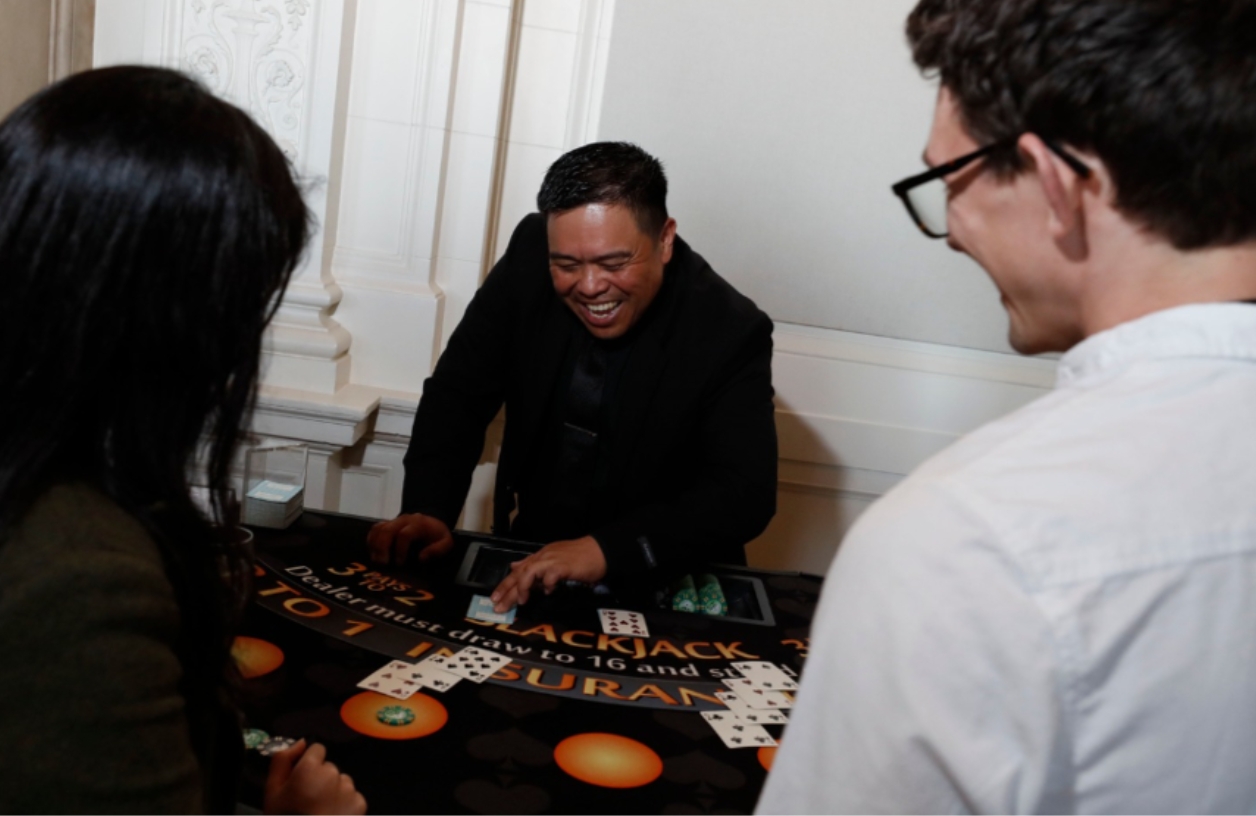 guests gathered around a casino table at an event