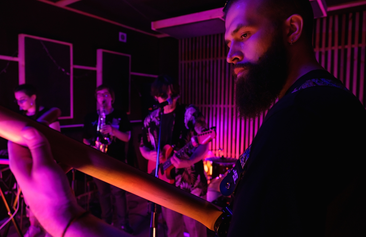 live band playing passionately at a casino party with guitars, a keyboard, and a saxophone