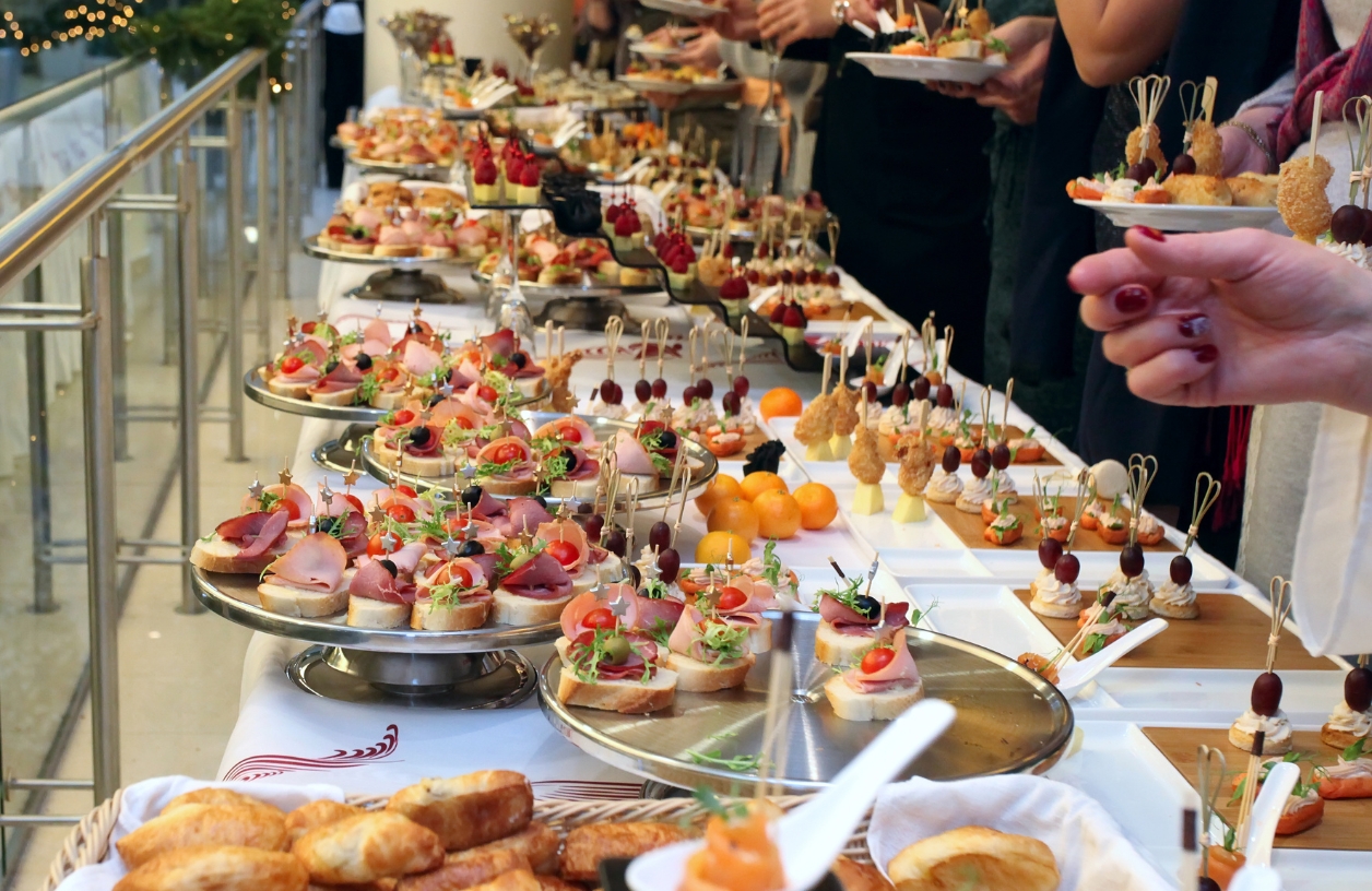 a table spread of finger foods including fruits, croissants, cheese, and more perfect for a casino party