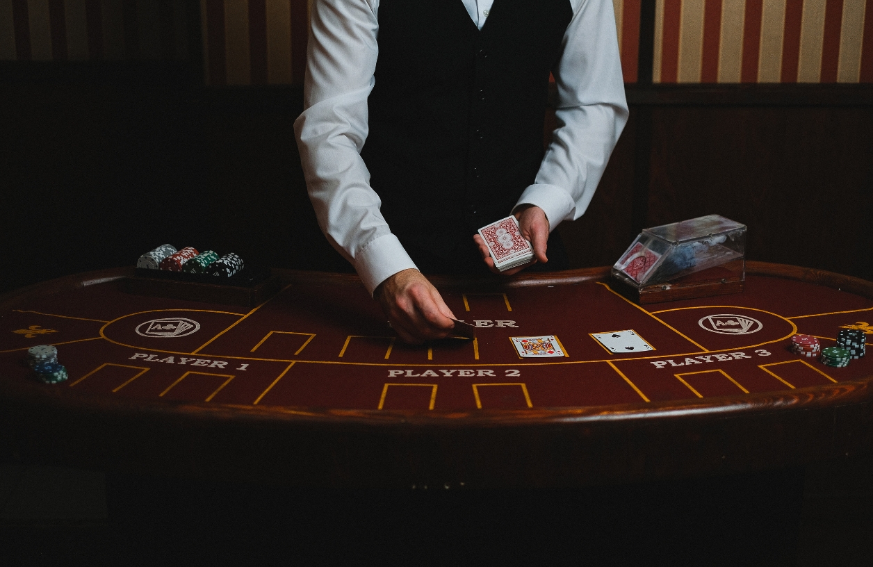 dealer at a casino night party in dim lighting