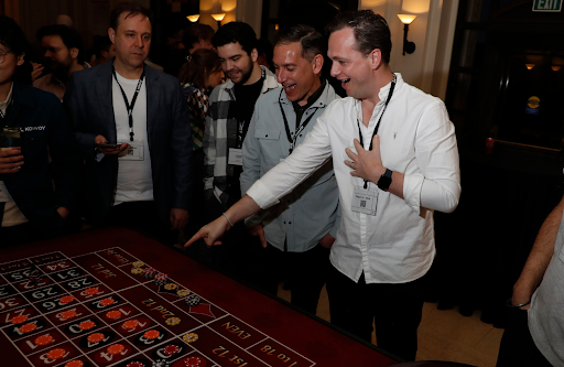 players pointing excited at a roulette table at a casino party