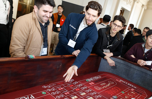 people playing craps around a table at a casino party