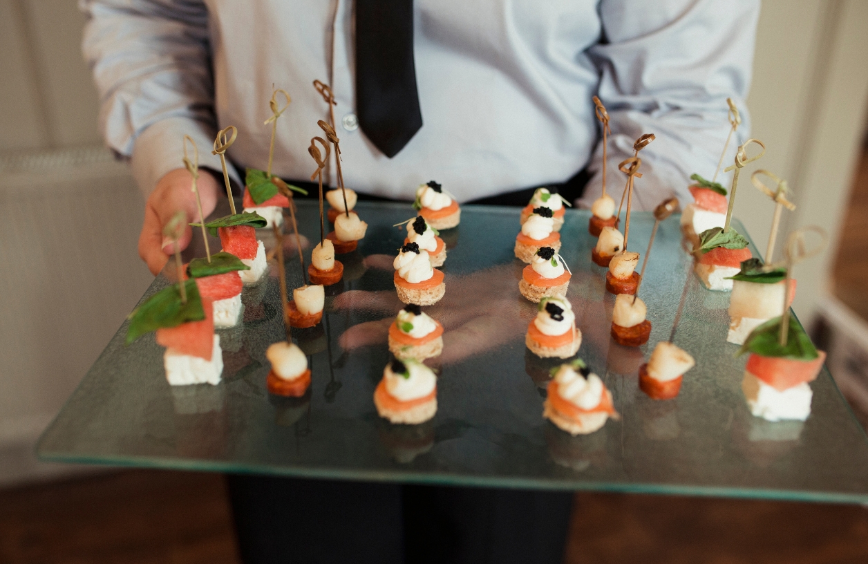 man serving finger foods at a casino party