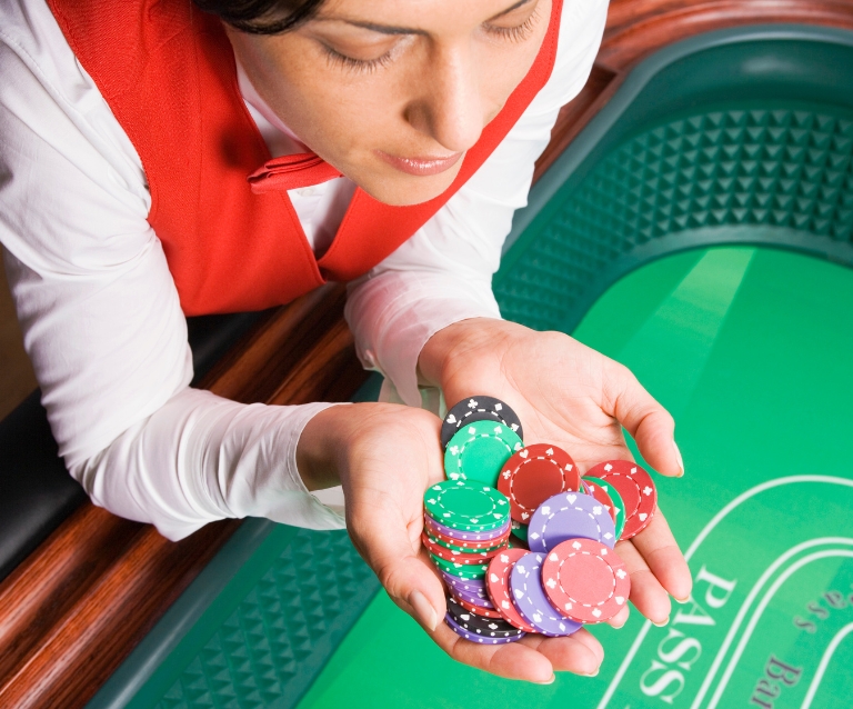 casino dealer counting chips