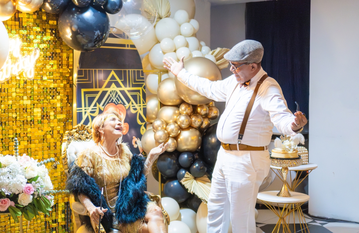 an older couple dressed in roaring twenties era clothing at a gatsby themed casino party