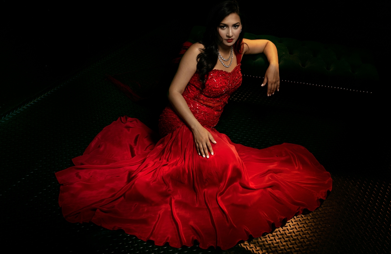 a woman in an elegant red evening gown that is an example of a monte carlo casino theme outfit for women