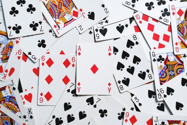 photo of scattered playing cards in red, black, gold, and blue