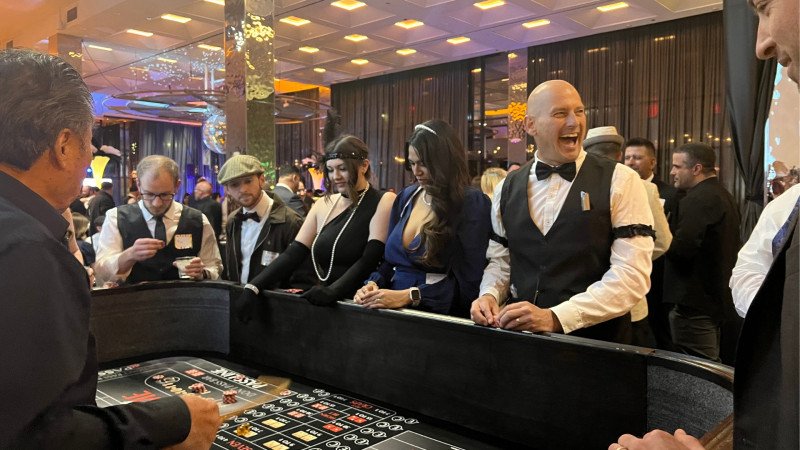 craps table players having fun at employee appreciation casino night in San Jose